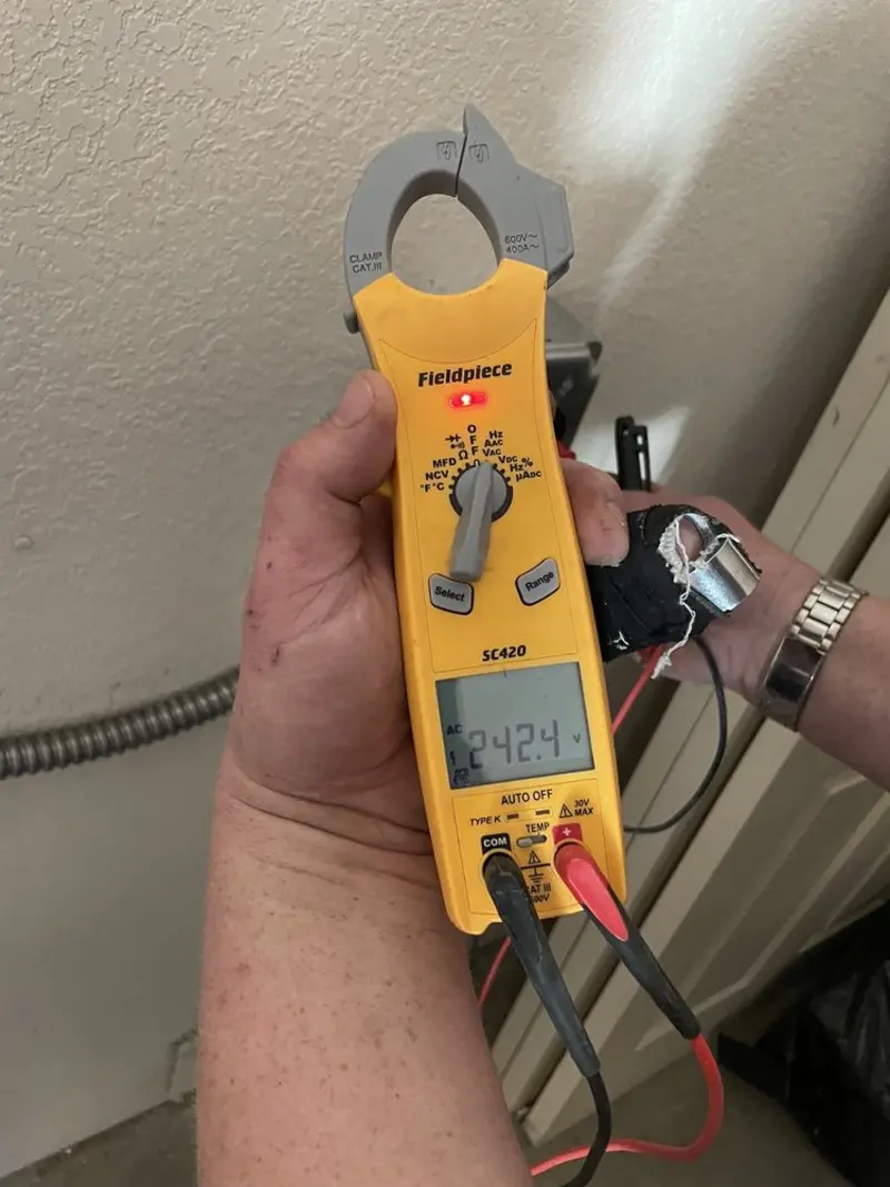Voltage testing with clamp meter during Whole House Surge Protector in Kirtland
